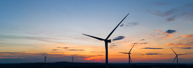 wind turbine in the countryside in the time of sunset background. Wind Turbines at Sunset. Aerial...