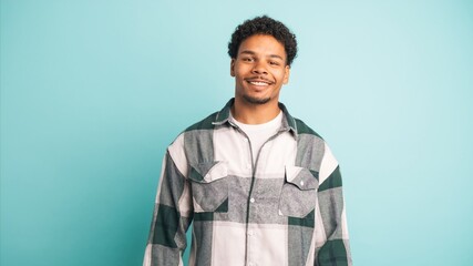 Happy young man in shirt looking at camera