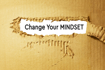 Change your thinking, text under torn cardboard, on white background.