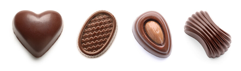 Set of different chocolate candies on white background, top view