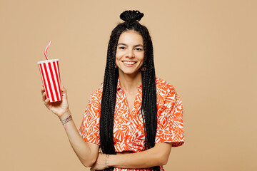 Young happy Latin woman she wears orange casual clothes hold in hand cup of soda pop cola fizzy...