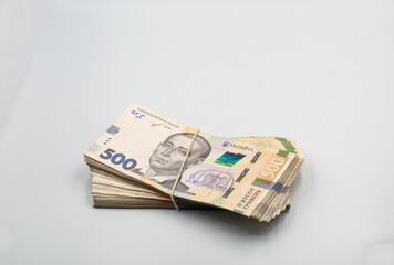 Ukrainian hryvna currency notes bounded together closeup on white.