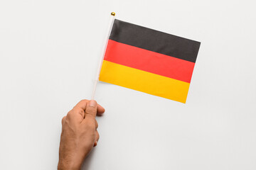 Male hand with flag of Germany on white background