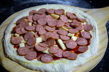 Calabrian sausage pizza served on a round board and set table