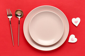 Beautiful table setting with hearts on red background. Valentine's Day celebration