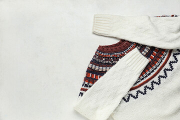 Stylish female sweater on light background