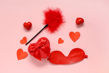 Composition with sex toys, gift box and paper hearts on pink background. Valentine's Day celebration