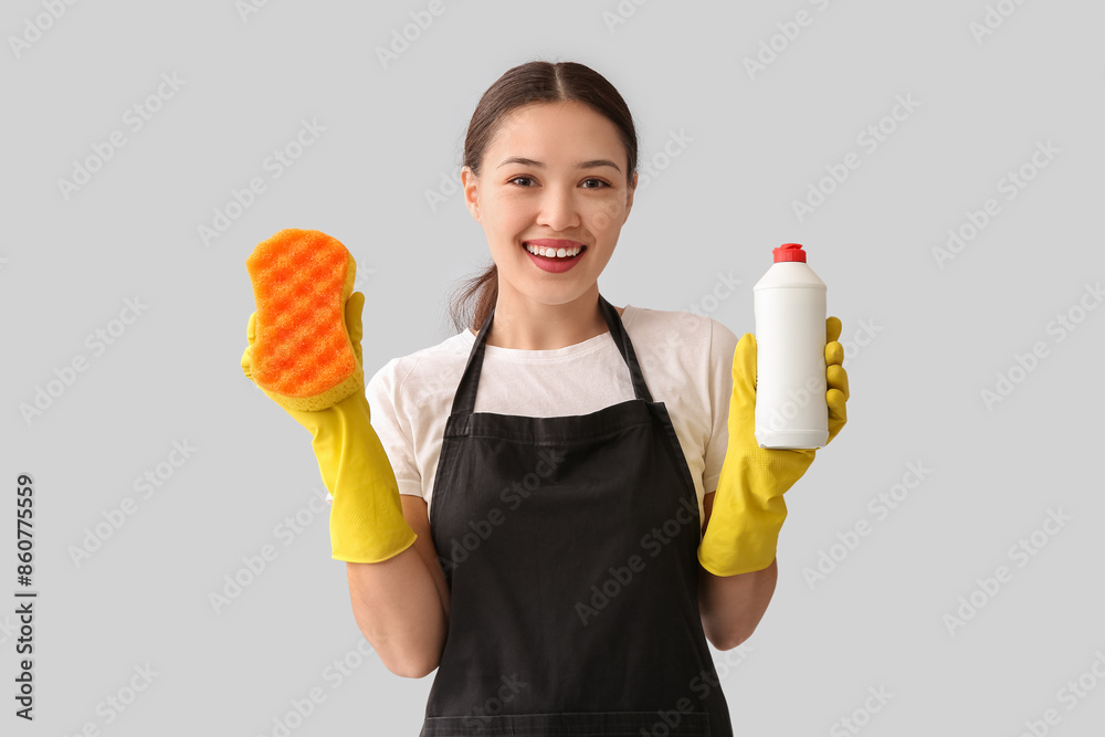 Canvas Prints Young woman with sponge and detergent on light background