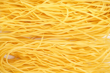 Delicious uncooked spaghetti pasta as background