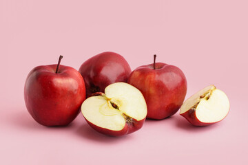 Fresh red apples on pink background