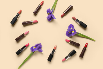 Obraz premium Frame made of lipsticks with flowers on beige background