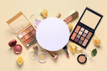 Fototapeta premium Blank card with makeup products and roses on beige background