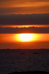 Naklejka premium Beautiful colors are on display as sun sets over the ocean outside Kristiansund, Norway.