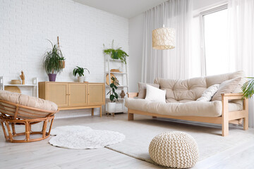 Interior of living room with sofa, armchair and commode