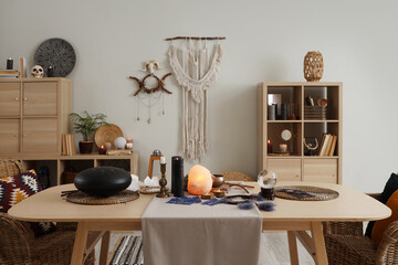 Interior of witch's room with magic attributes, table and shelf unit