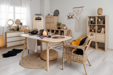 Interior of witch's room with magic attributes, table and drawers