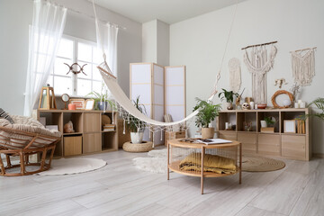 Interior of witch's room with magic attributes, table and hammock