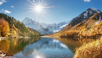 Fototapeta premium Majestic Mountain Lake with Snow-Capped Peaks and Sparkling Sun.