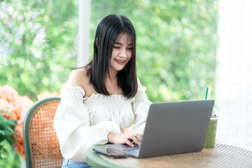 asian freelance people business female talking making using casual working with laptop computer for browsing internet, chatting and blogging and smartphone,notebook in coffee shop.