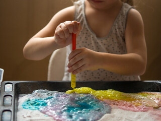 a child makes experiments with chemicals. experiments with soda and citric acid