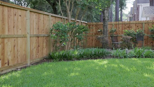 Large back yard with new fence on windy day