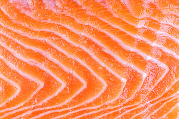 Texture background of fresh raw salmon or trout sea fish fillet macro, close up, top view. Healthy...