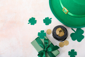 Pot with golden coins, leprechaun hat and gift box on light background. St. Patrick's Day...