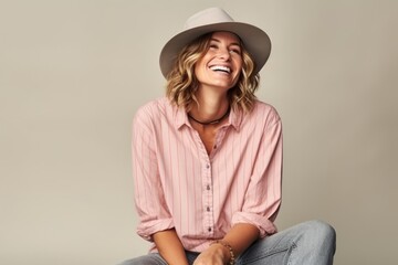 Portrait of a beautiful young woman wearing a hat and a shirt