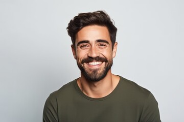 Obraz premium Portrait of handsome young man with beard smiling and looking at camera