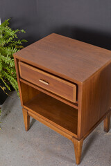 Vintage 1960s nightstand with classic styling. Walnut furniture with expressive grain pattern. Home interior product photograph.