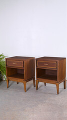 Vintage 1960s nightstand pair with classic styling. Walnut furniture with expressive grain pattern. Home interior product photograph.