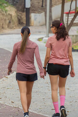 Latin Young Women Walking Together on Park Path