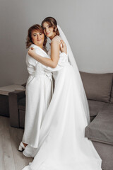 Fototapeta premium A woman in a white dress holding a bouquet of flowers. She is smiling and looking at the camera