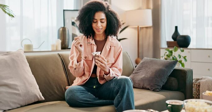 Happy, woman and eating ice cream or dessert on sofa for rest, relax and fun with sweet memory or idea. Excited, female person and gelato or frozen yogurt with spoon for candy decision or choice