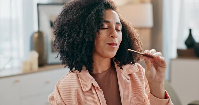 Smile, eating and woman with chocolate on sofa in living room for sweet treat, snack or craving. Happy, relax and female person enjoying cacao sugar dessert or candy bar in lounge at apartment.