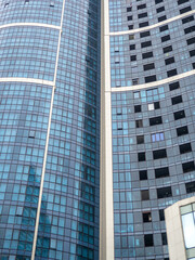 Construction of a modern multi-storey building. Glazed facade. Background from windows.