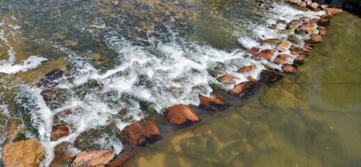 water flowing through rock in the river