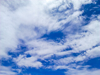 The sky has the light of the sun, the sky is blue, there are small and large clouds alternating and moving slowly, with the sunlight passing, creating a miraculous abstract shape, summer concept