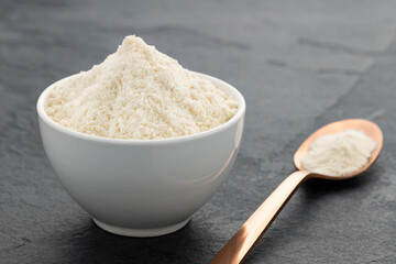 Collagen protein in the bowl and spoon - Organic gelatin powder
