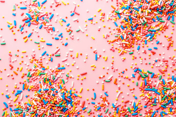 Trendy pattern of colorful sprinkles for background of design banner, poster, flyer, card, postcard, cover, brochure over pink
