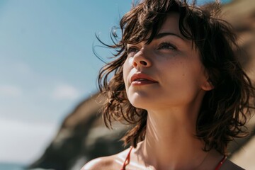 Portrait of a beautiful young girl on the background of the sea