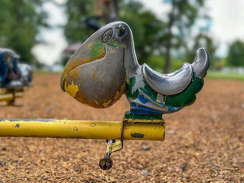 Old, retro, used weathered metal park playground spring rocker, rocking, equipment.	