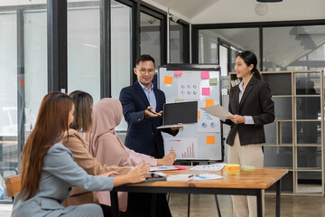 Asian Business Group Chat about graph work Present in meetings, in the office