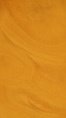 Shimmer fluid spill. Glitter paint texture. Blur orange golden color metallic shiny sand particles acrylic liquid pigment ink flow abstract art background.