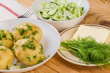 Boiled young potatoes and vegetable salad, dill and butter separatelly