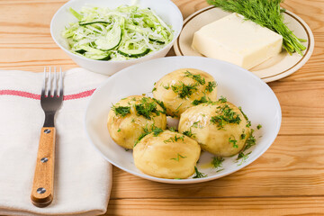 Boiled young potatoes and vegetable salad, dill and butter separatelly