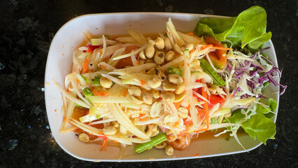 Top VIew.Thai papaya salad consists of papaya, roasted peanuts, chili, lime and tomatoes.