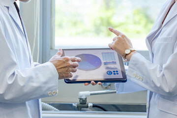 Doctors or researchers consulting while looking at a tablet PC