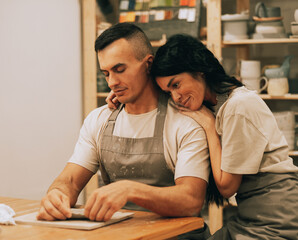 A young couple is engaged in creativity in a pottery workshop