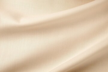 Real textured background of smooth beige silk fabric flowing and forming soft folds
